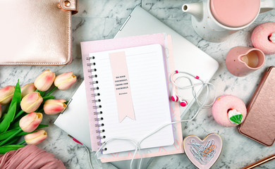 Feminine desk with modern touch screen laptop and rose gold accessories