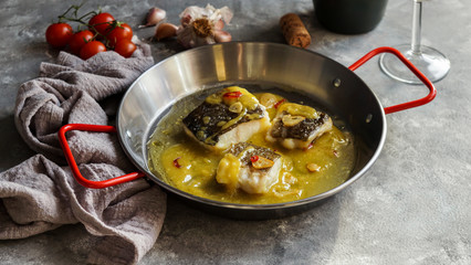 bacalao al pil pil, salted cod in emulsified olive oil sauce, spanish cuisine, basque country