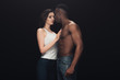 © LIGHTFIELD STUDIOS - beautiful seductive interracial couple in denim isolated on black