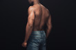 back view of sexy muscular african american man in denim posing isolated on black