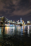 Fototapeta Nowy Jork - Blurred view of Financial District at night from East River