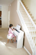 © ipek - Girl Playing a White Piano
