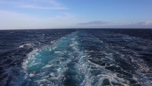 Slow Motion Footage Of Wake In The Deep Blue Pacific Ocean With A Blue Sky