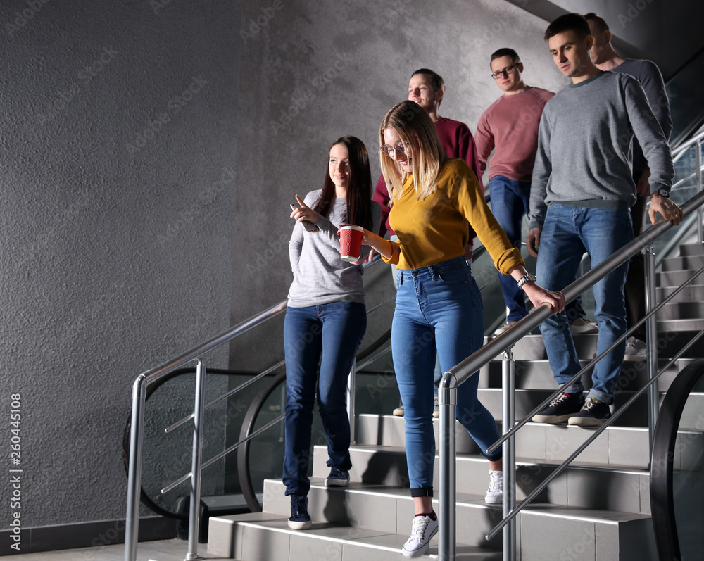 Young colleagues in the stairway during coffee break