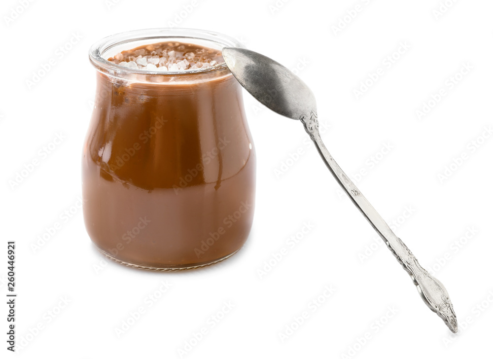 Jar of tasty salted caramel on white background