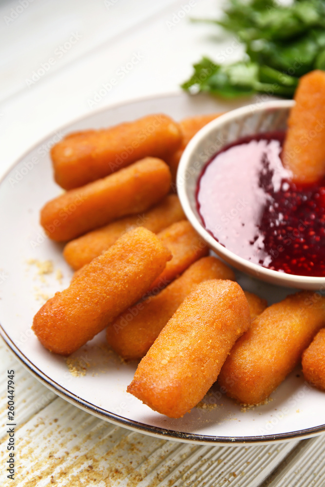 Plate with tasty mozzarella sticks and jam on white table