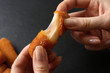 © Pixel-Shot - Woman eating tasty mozzarella sticks, closeup