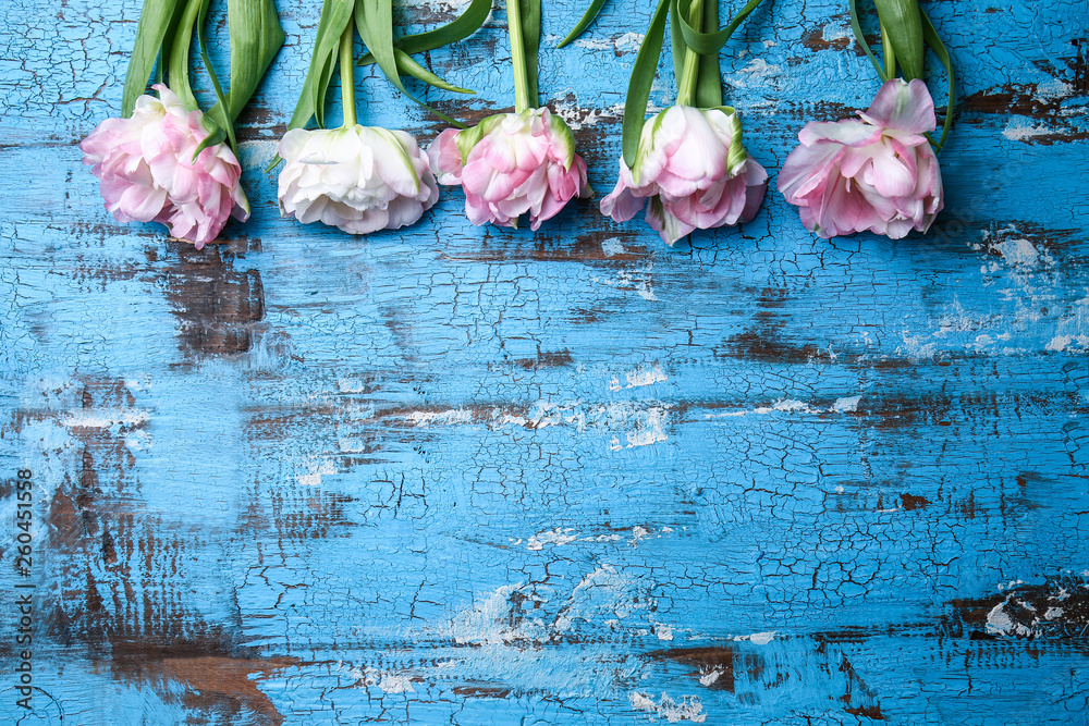 Beautiful tulips on wooden background
