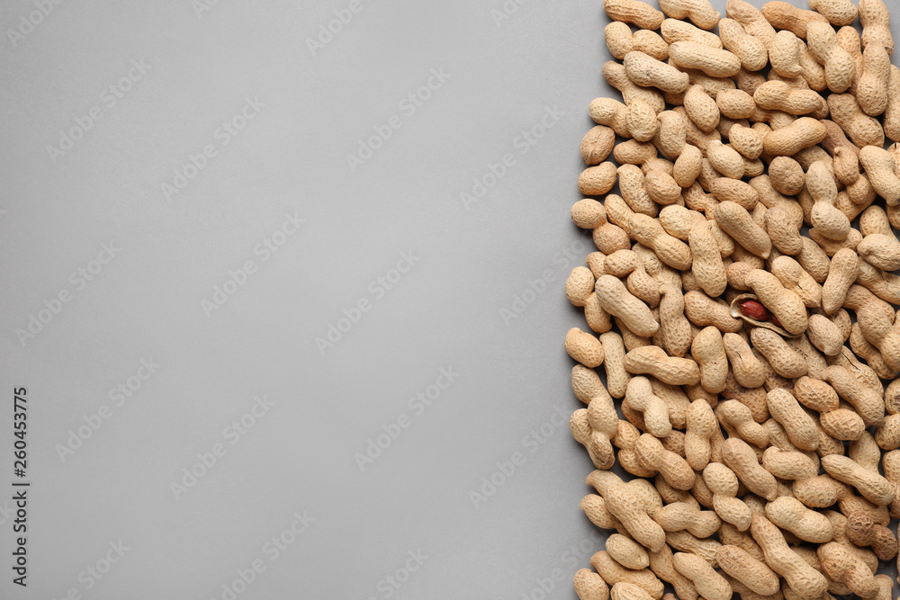 Tasty peanuts on grey background