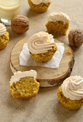 Wall Mural - Carrot coconut cupcakes with walnut covered  cream cheese, vertical 