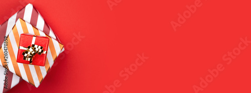Top view of gift boxes on red background.