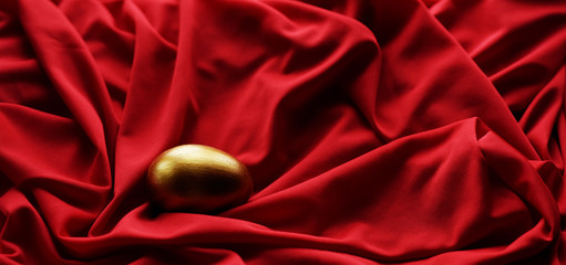 Sticker - Easter egg hand painted gold on a red background