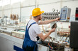 © JustLife - Factory worker. Man with helmet working with pvc.