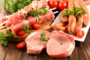 Poster - assorted raw meats on wood background