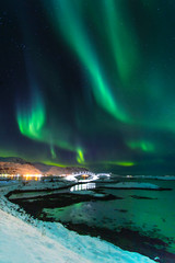 northern lights in winter time in norway, amazing view at night in norway with a bridge in lofoten i