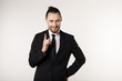 © Vasya - Happy beautiful bearded guy with good-looking hairstyle, wearing black suit and tie