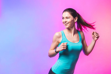 Portrait of young woman running isolated against white background.