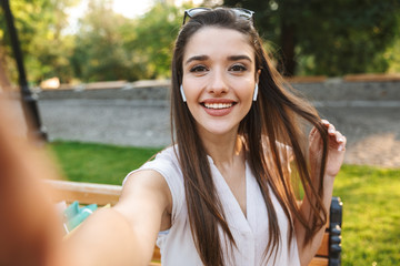 Canvas Print - Beautiful young woman taking a selfie=