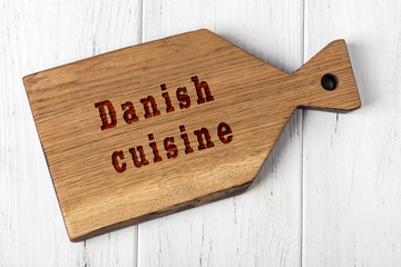 Wall Mural - Wooden cutting board with inscription. Concept of danish cuisine