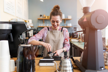 Wall Mural - Female barista making coffee 