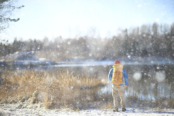 winter landscape man with a backpack / nature landscape a man on a hike with equipment in snowy weather in Canada