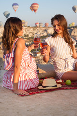 Friends toasting rose wine glass and having fun outdoors