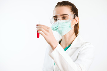 Wall Mural - Young nurse holding a test tube, testing liquid.