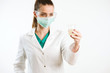 © JustLife - Young nurse holding a test tube, testing liquid.