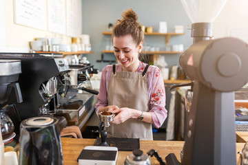 Wall Mural - Female barista making coffee 