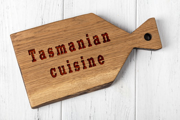 Wall Mural - Wooden cutting board with inscription. Concept of tasmanian cuisine