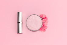 Flat Lay Composition With Decorative Makeup Products And Flowers On Pastel Pink Background.