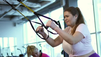 Wall Mural - Fat woman works out in gym to lose weight