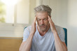 © goodluz - Mature man with bad headache at home