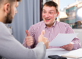 Canvas Print - Satisfied man with partner working with documents at home