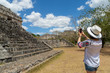 © Irina - Tourist in the archaeological area takes pictures on the smartphone. Ancient Maya city of Ek Balam. Archaeological zone of the ancient Mayan civilization, Yucatan, Mexico