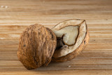 Fototapeta  - Opened walnut on a wooden board