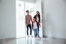 Family Asian Entering Their New Home. Buying New House Concept