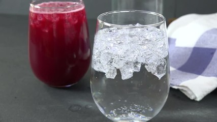 Wall Mural - Sparkling water bubbling up in a cocktail glass, slow motion