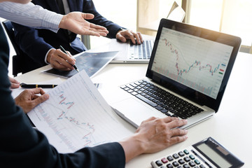 Poster - business man and woman sit at ther table looking at computer laptop