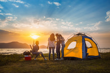 Group Of Asian Women Party With Drink Bottles Enjoy Travel Camping,trekking In Vacation Time At Sunset.