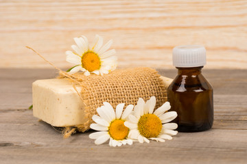 homemade natural soap and organic oil with chamomile flowers