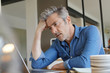 © goodluz - Mature man working from home looking stressed