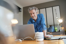 Mature Man Working From Contemporary Home