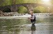 © goodluz - Mature man fly fishing in beautiful river