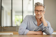 © goodluz - Portrait of handsome mature man wearing glasses smiling at camera