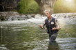 © goodluz - Mature man fly fishing in beautiful river