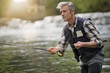© goodluz - Mature man fly fishing in beautiful river