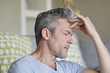 © goodluz - Mature man with bad headache at home