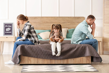 Poster - sad family sitting on bed after quarrel