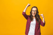 © denis_vermenko - Winning success woman happy ecstatic celebrating being a winner. Dynamic energetic image of multiracial Caucasian Asian female model isolated on yellow background waist up.